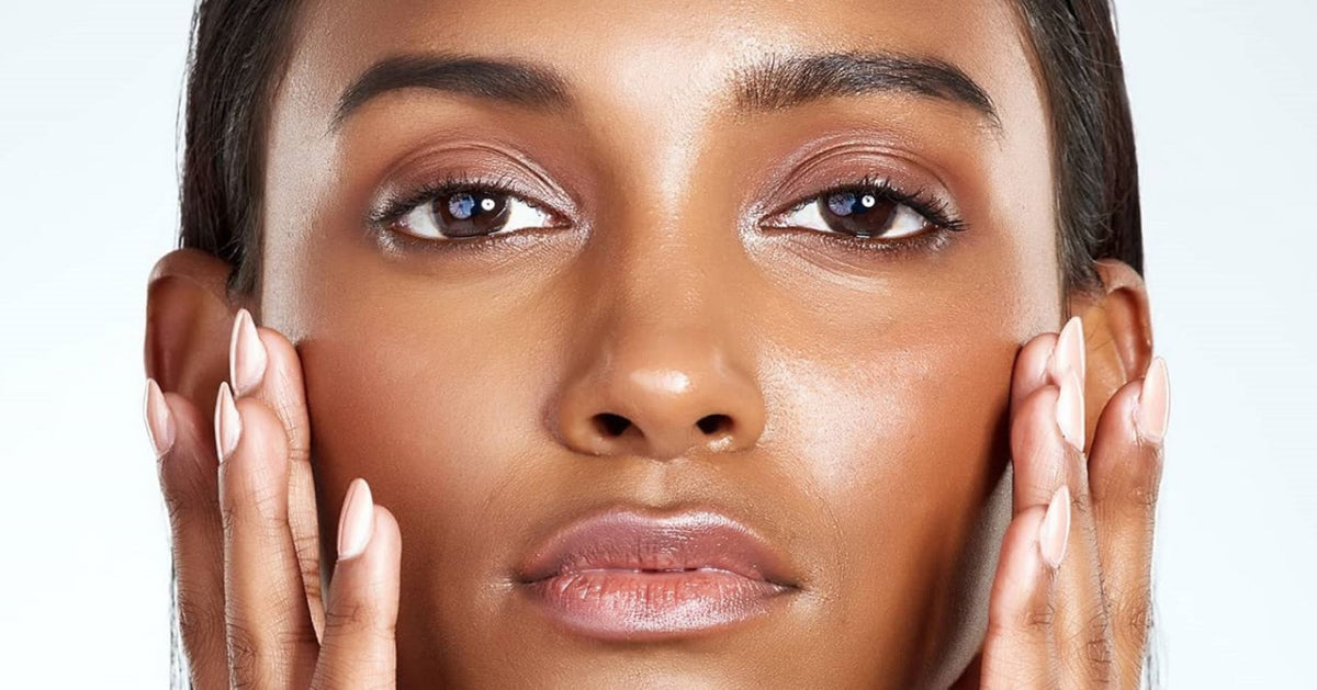 Woman gently touching her cheeks during a skincare routine