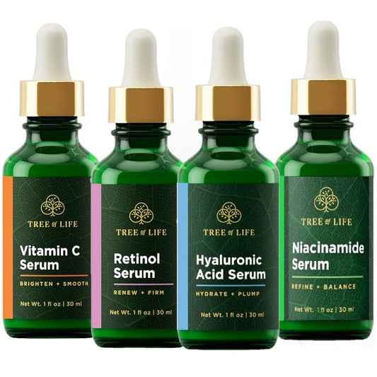 Green skincare serum bottles with gold caps: Vitamin C, Retinol, Hyaluronic Acid, Niacinamide