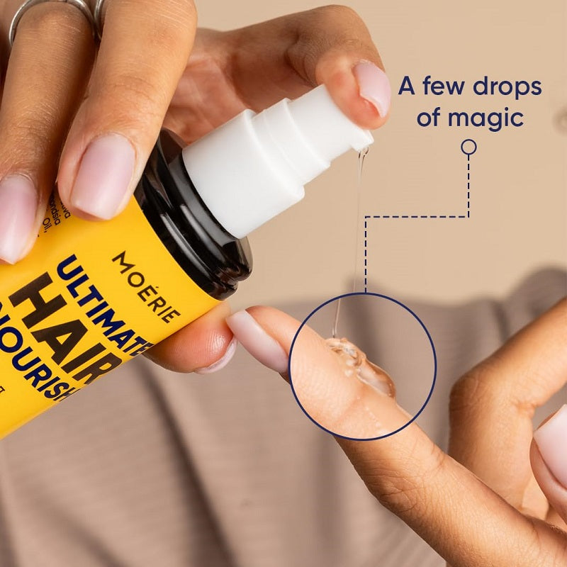 Hair oil application, hand dispensing white nozzle drops onto hair strand