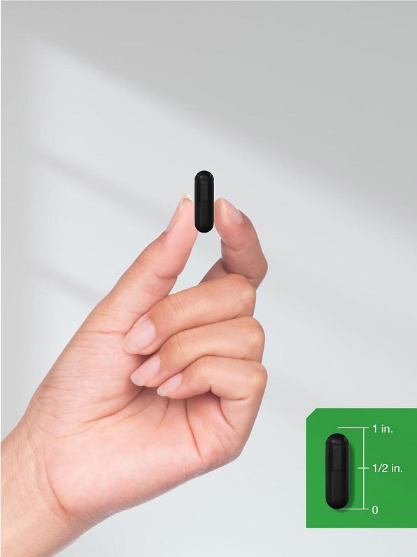 Activated charcoal capsule held in hand from Horbaach ActiCoal 780mg bottle
