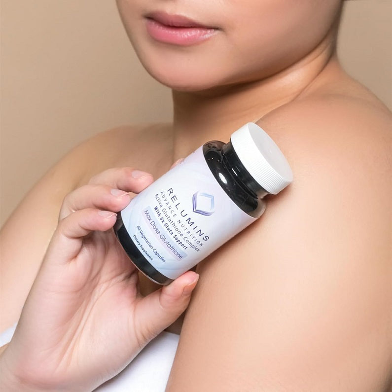 Relumins supplement bottle with white cap held in hand