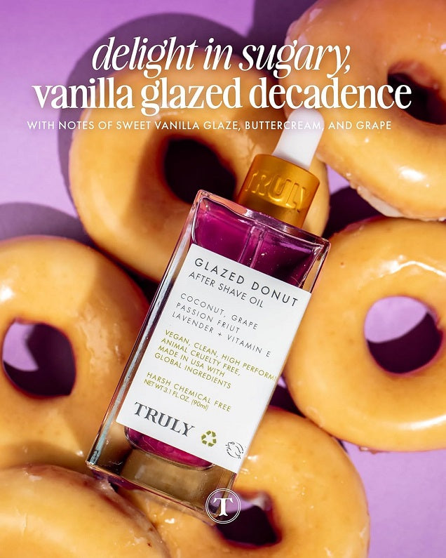 After shave oil bottle, Glazed Donut vanilla scent, in front of glazed donuts