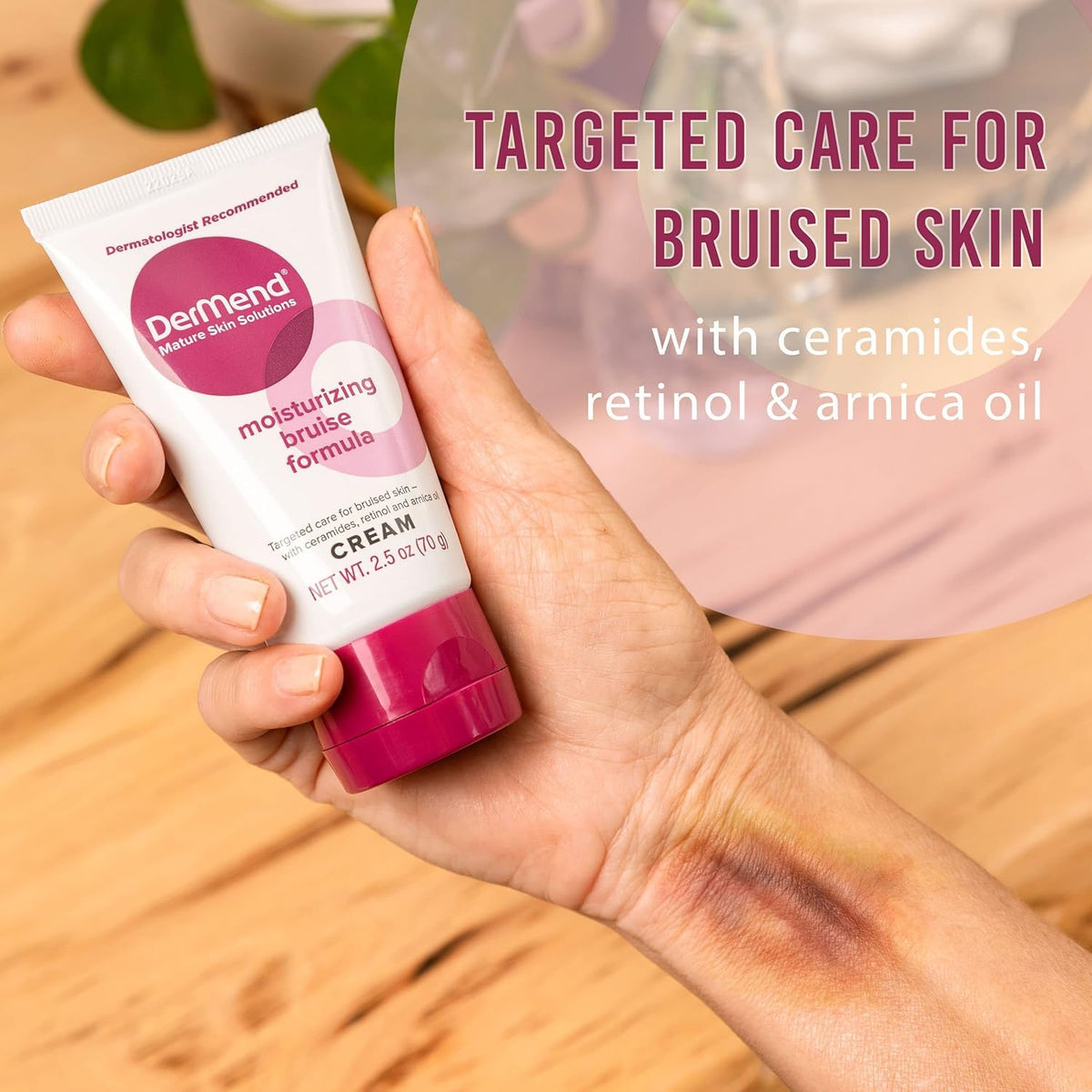 Moisturizing bruise formula cream tube in hand, white tube with pink base
