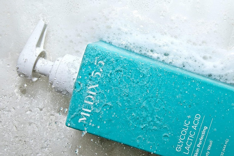 Medix 5.5 glycolic and lactic acid body wash bottle with water droplets