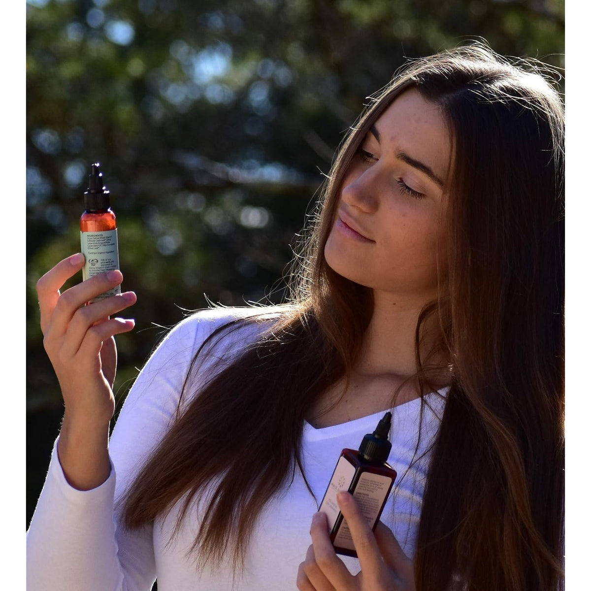 Woman holding volumizing dry shampoo bottle and applying to hair