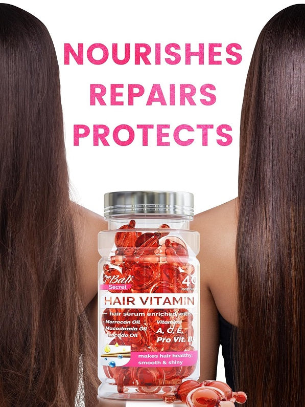 Hair treatment serum bottle with red capsules between long hair strands