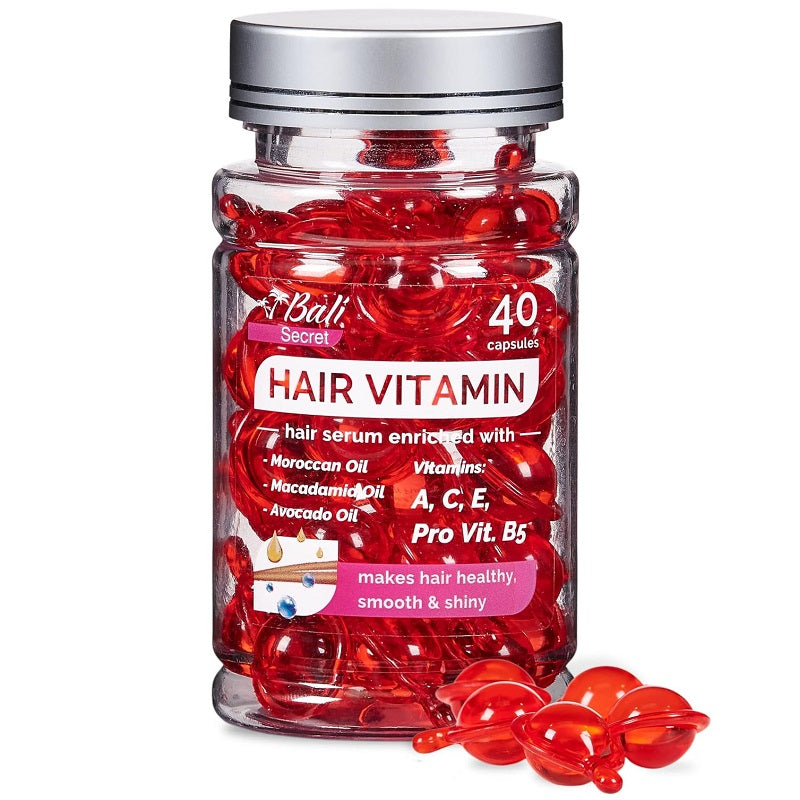Hair vitamin treatment serum in red capsule bottle with silver cap