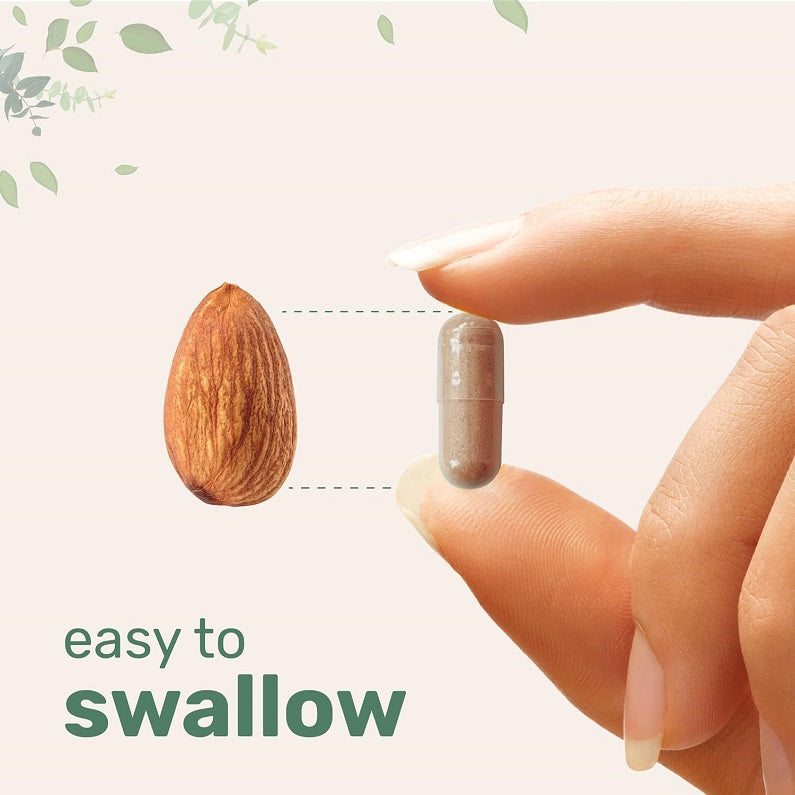 Vegetarian liposomal NAD+ capsule held between fingers for easy swallowing