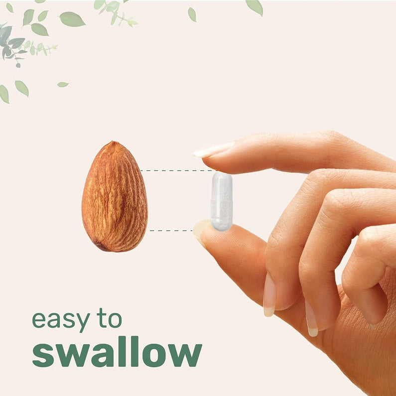 Single NMN capsule held between fingers, easy to swallow