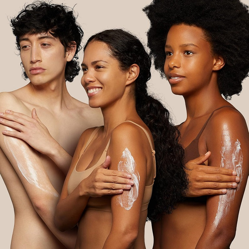 Body lotion being applied to arms and shoulders, visible cream on skin