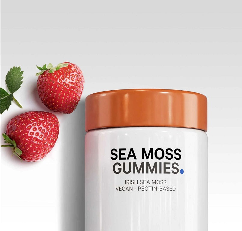 Sea moss gummies supplement bottle with orange lid and strawberry label, close-up