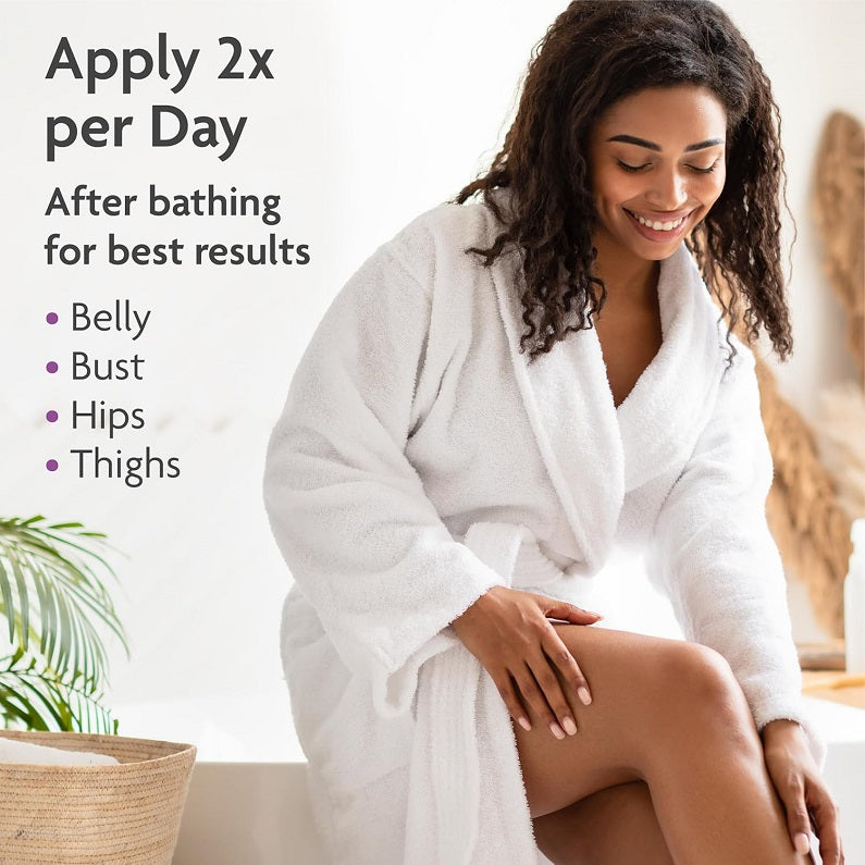 Maternity stretch mark prevention cream application on belly, woman in bathrobe