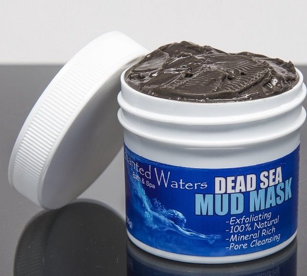 Dead Sea mud mask jar with open lid and dark clay on top