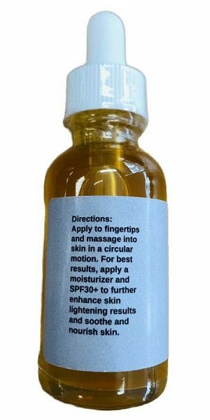 Skin whitening serum bottle with blue cap and directions label, amber glass.