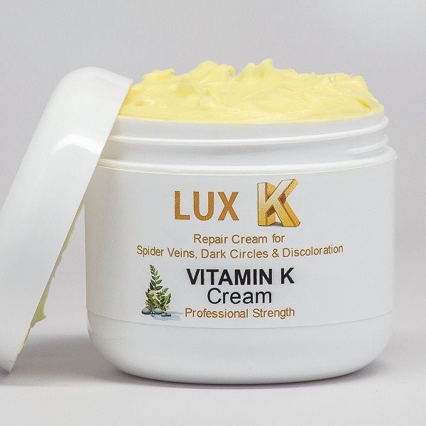 Vitamin K cream jar with open lid showing pale yellow cream texture