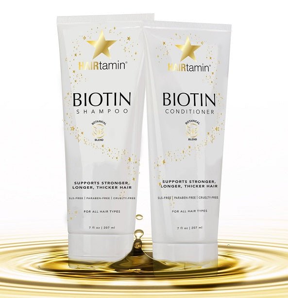 Biotin shampoo and conditioner tubes with gold liquid splash at base