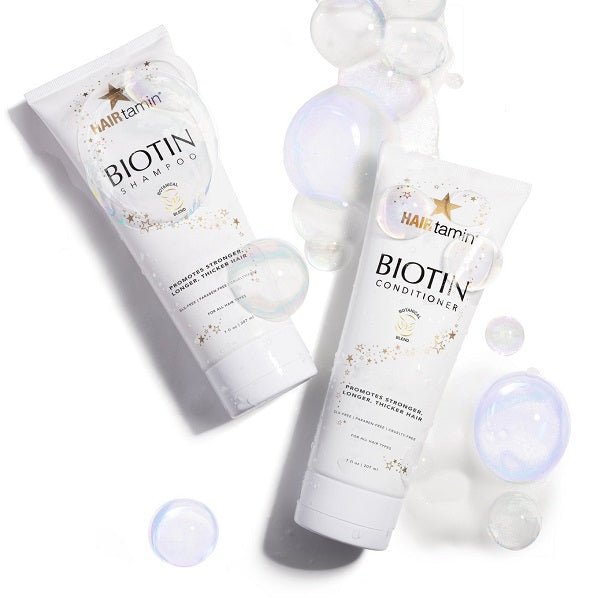 Biotin shampoo and conditioner tubes with translucent bubbles around bottles