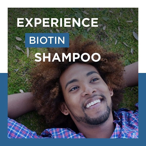 Biotin shampoo experience banner with smiling man, dark hair, on grass background
