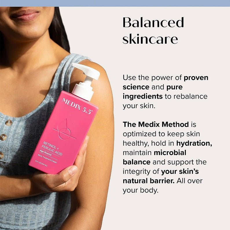 Retinol + ferulic acid body cream bottle held with a white pump on skin.