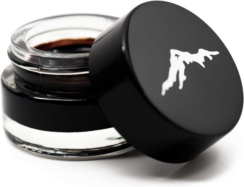 Shilajit soft resin jar close-up with open lid, showing dark resin inside.