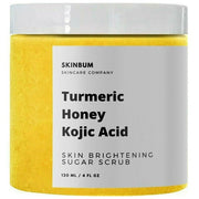 Turmeric honey kojic acid sugar scrub jar with visible yellow sugar texture