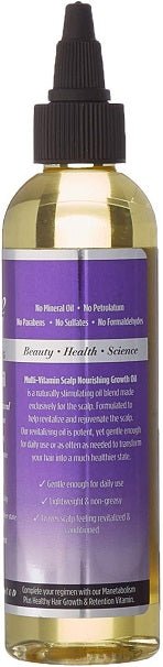 Hair growth oil bottle back label close-up with black dropper and amber liquid