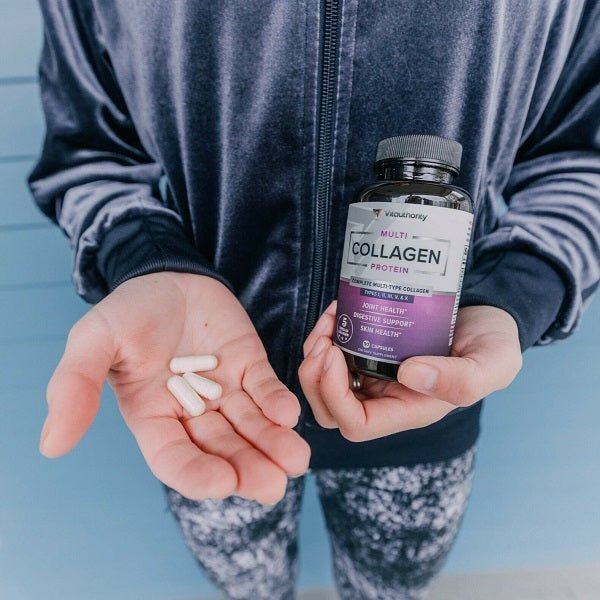 Person holding Vitauthority multi collagen capsules bottle and a few capsules in hand