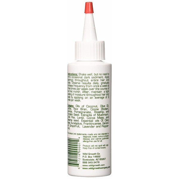 White hair oil bottle back label with ingredient text, red cap